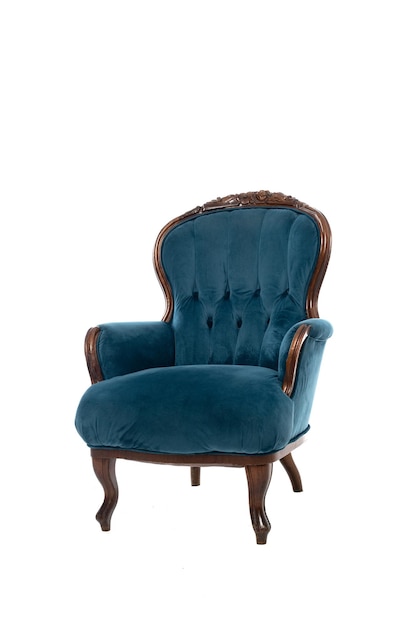 A blue velvet chair with a wooden frame is shown in a white background.