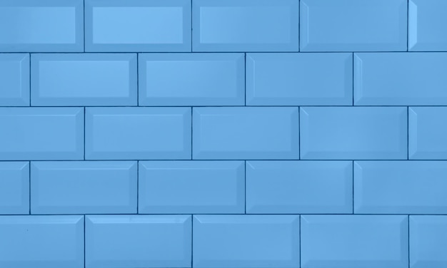 A blue wall that is made of bricks.