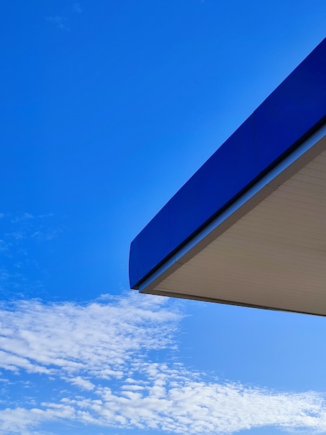 A blue wall with a cloud in the sky