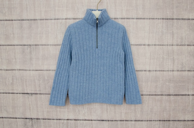 Blue warm jacket hanging on a hanger