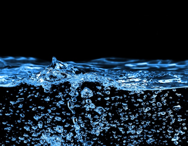 Blue water and air bubbles in the pool over black background with space for text