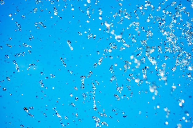 Blue water drops on blue sky, water background series.