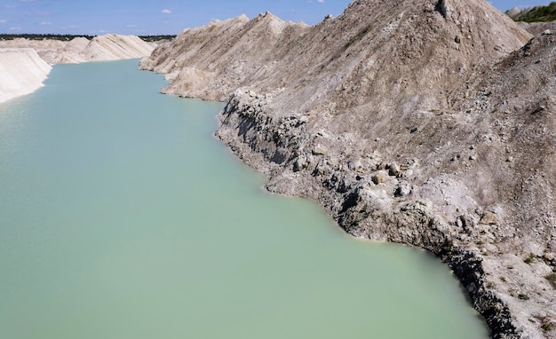 Blue water river running through an industrial chalk quarry