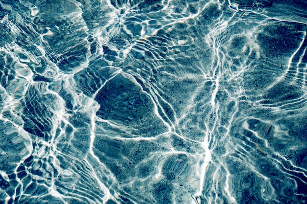 Blue water surface viewed from above in outdoor sea sun reflection dimply Surface Background