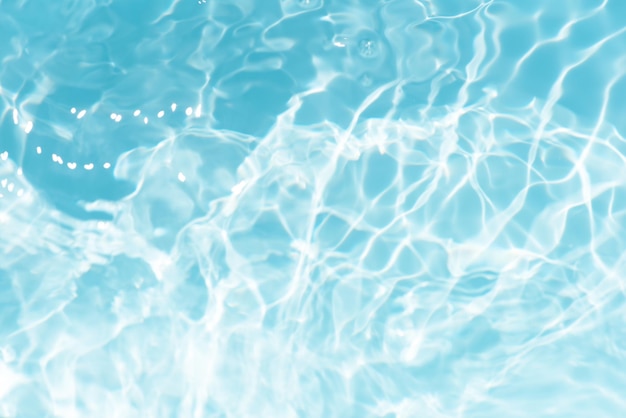 a blue water surface with a white foamy pattern