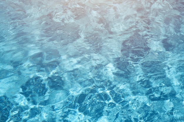 Blue water in swimming pool outdoors under the shiny sunlight