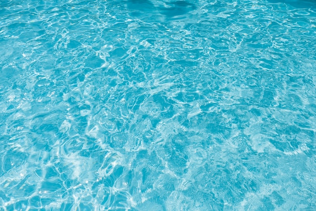 Blue water in swimming pool with sun reflection