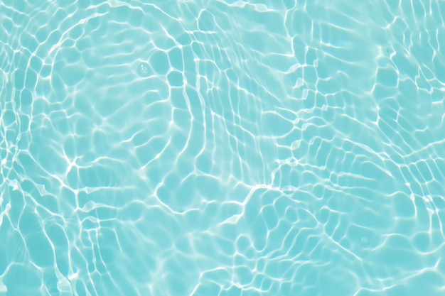 Blue water in a swimming pool with sunlight reflecting on the surface