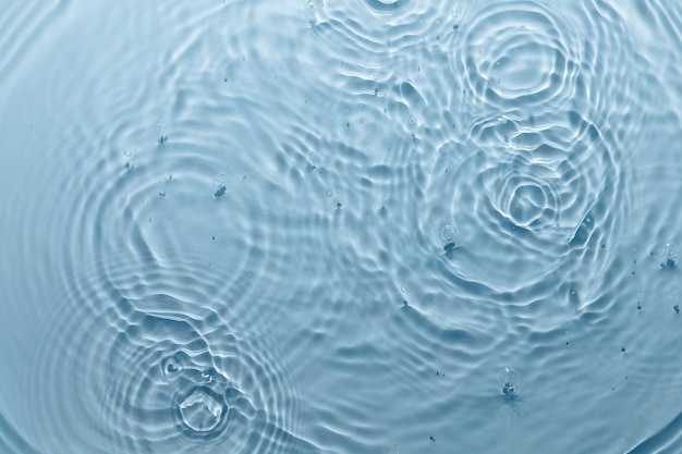 Blue water texture, blue pure water surface with waves and ripples. Flat lay, copy space