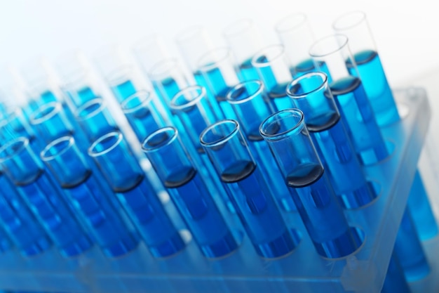 Blue water in a transparent testtube on light background