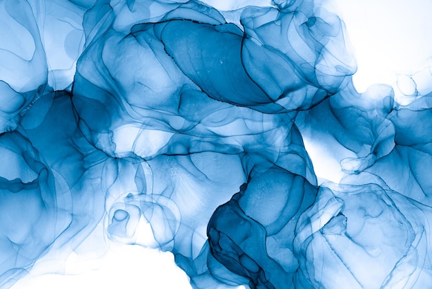 A blue and white background with a drop of liquid in it