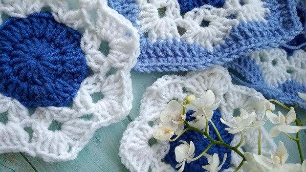 Blue white crochet elements and orchid Crochet texture place for an inscription adapted for mobile