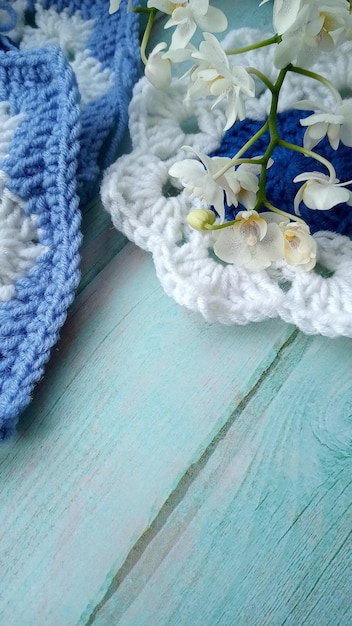 Blue white crochet elements and orchid Crochet texture place for an inscription adapted for mobile