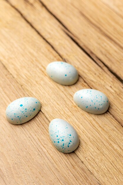 Blue and white eggs on a wooden table