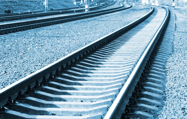 A blue and white image of a railway track with the word rail on it.