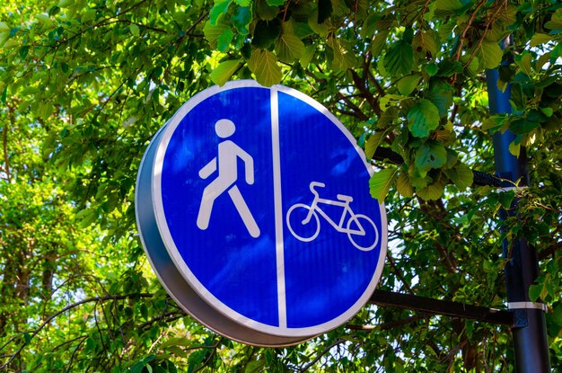 A blue and white sign that says " walk " and a bicycle on it.