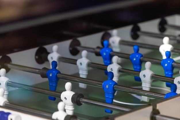 Blue and white table soccer players with the number 4 on them.