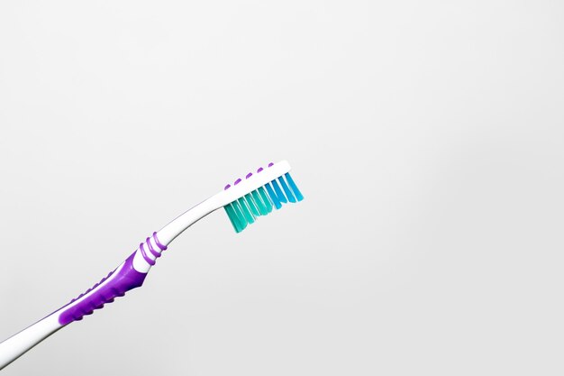 Blue white toothbrush isolated on a white background, copy space, dental concept