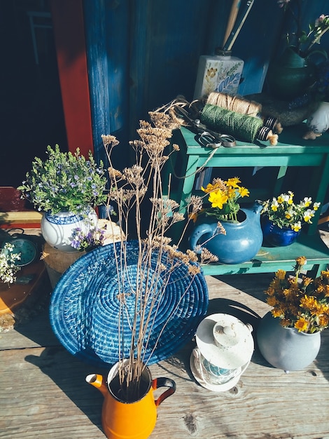 Photo blue wicker round dish wild yellow flowers in pot painter brushes in vasedaylight