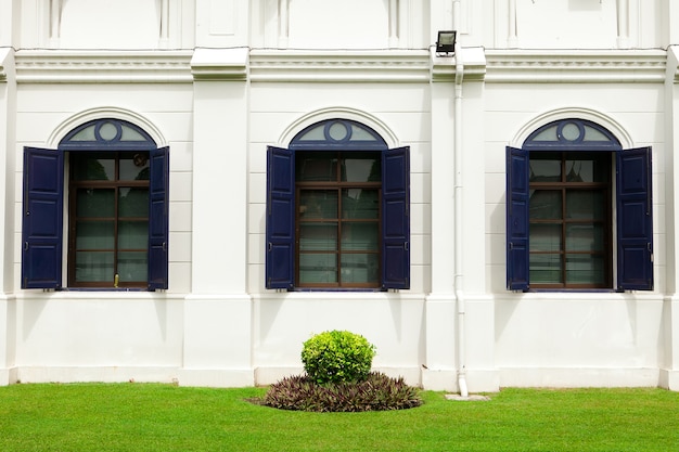 The blue window on the white wall 