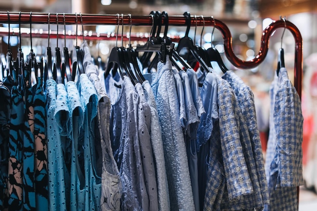 Blue women's clothes hanging on a hanger in a row