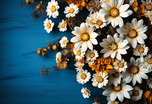 blue wooden background with white daisies and yellow daisies