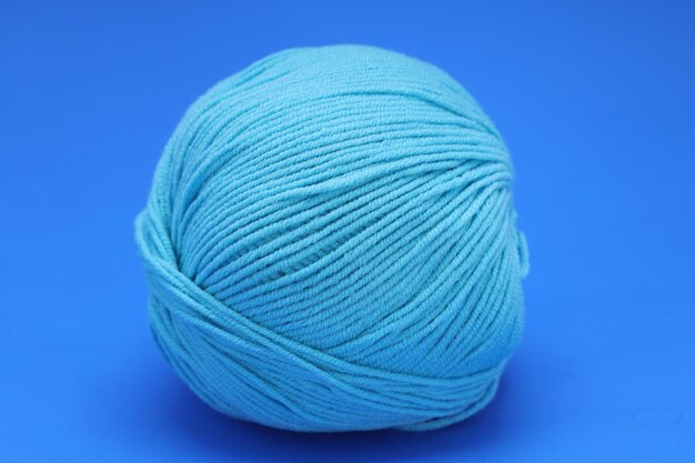 Blue wool ball on blue background. High quality photo