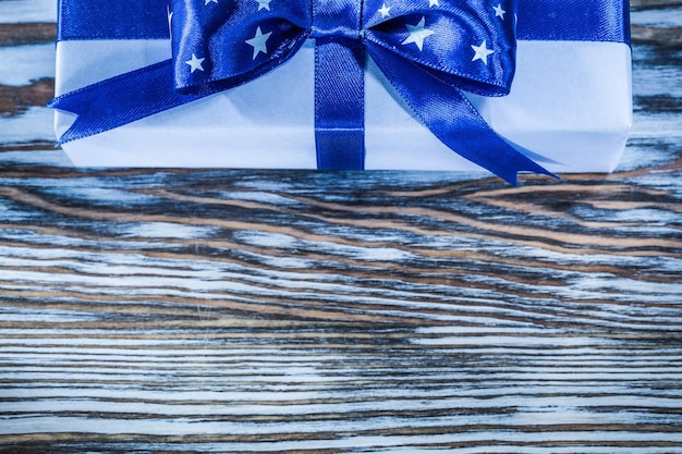 Blue wrapped present box on wooden board