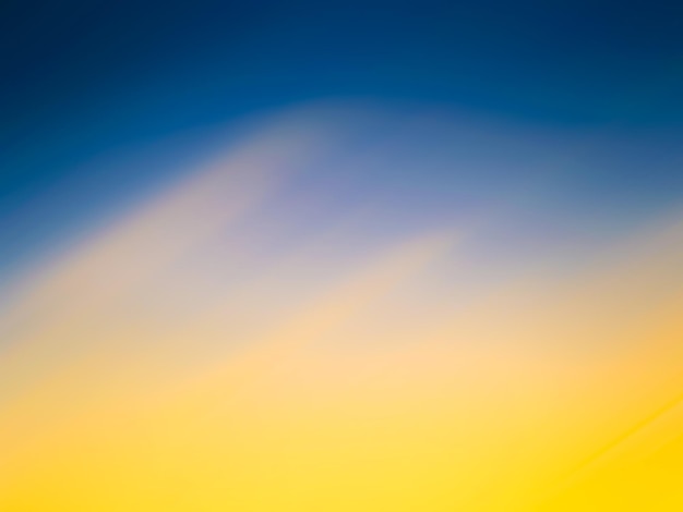 Photo a blue and yellow background with a yellow sky and a white cloud.