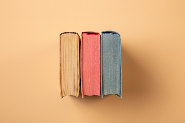 Photo blue, yellow and pink books on a cream background