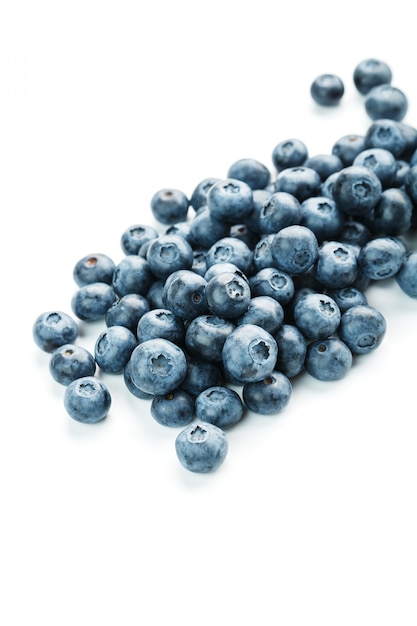 Blueberries are scattered on a white background