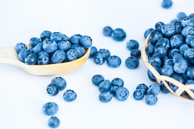 blueberries in bamboo basket on white background