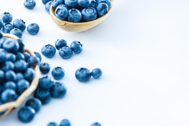 blueberries in bamboo basket on white background