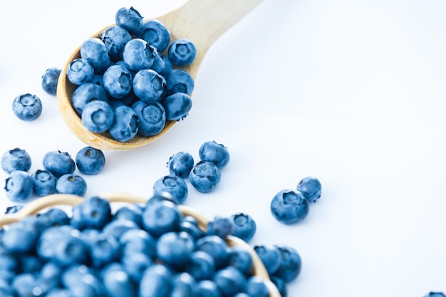 blueberries in bamboo basket on white background