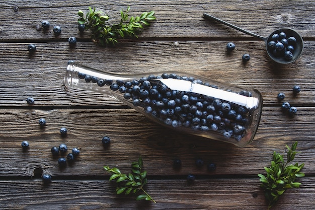 Blueberries in a bottle on wooden