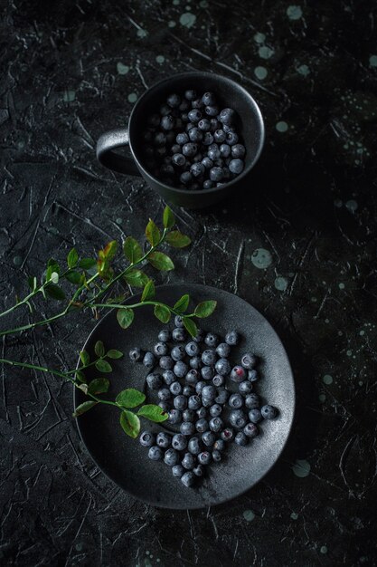 Blueberries in a cup, black background