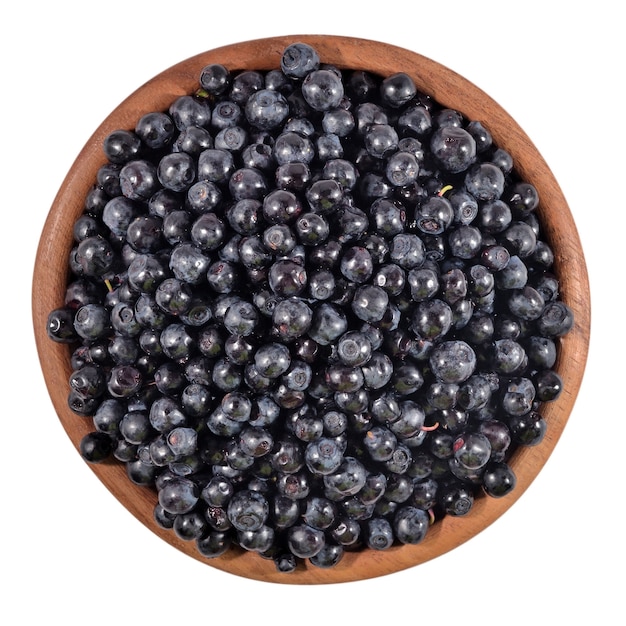 Blueberries fruit in a wooden bowl on a white