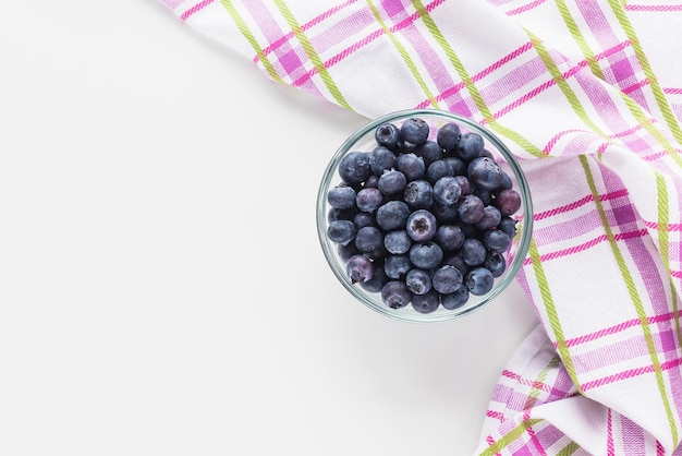 Blueberries in glass bowl on white background Top view copy space