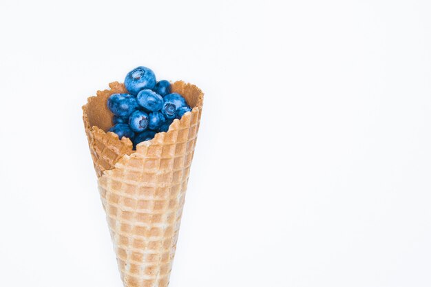 Blueberries and horn. Blueberry Blast. Photo of blueberries in a waffle cone. View from above. High Resolution Product.