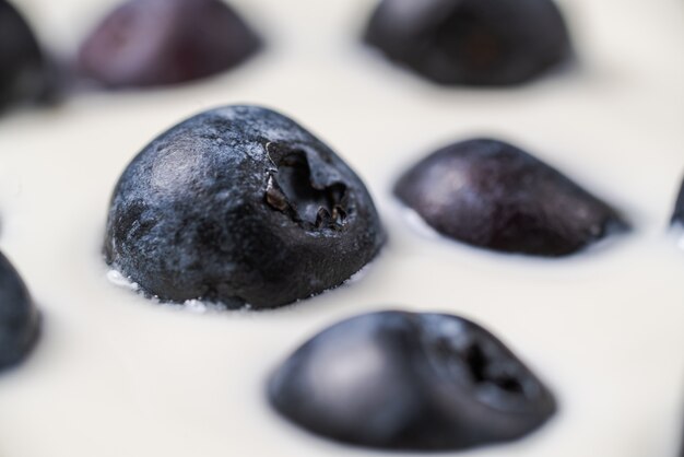Blueberries in organic yogurt, close up photo
