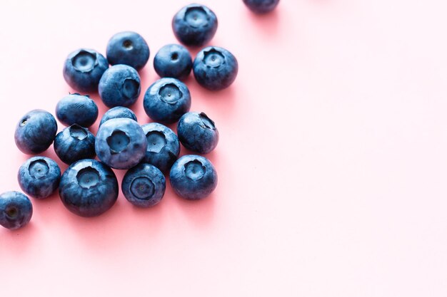 blueberries on pink background. Top view. Flat lay