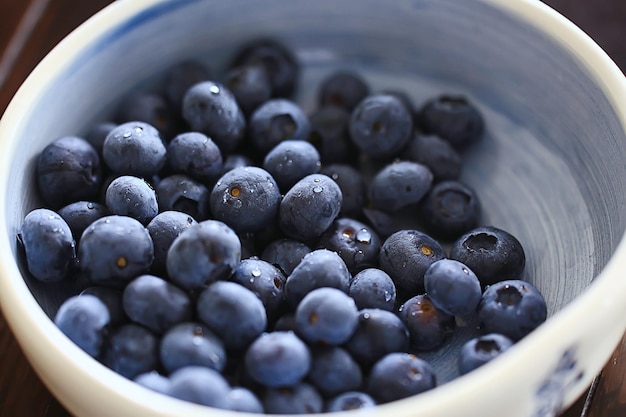 blueberries in a plate on the table background