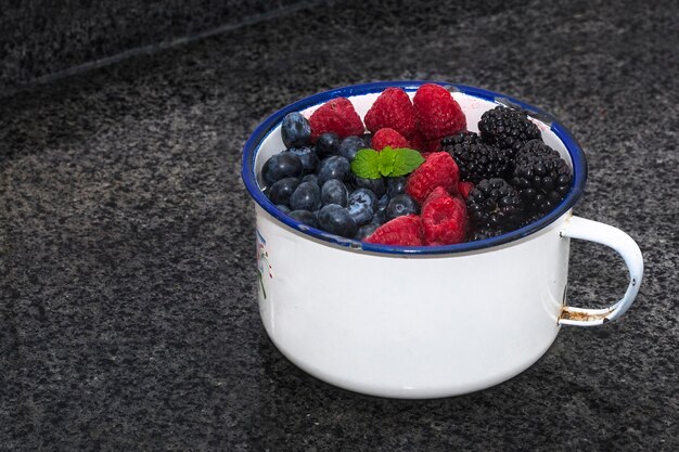 Blueberries raspberries blackberries in a container