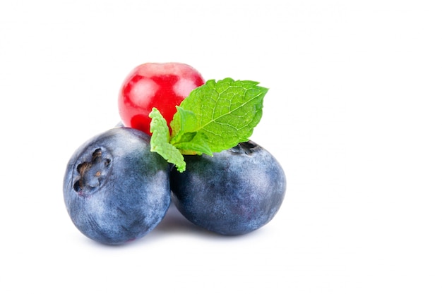 Blueberries and red currant. Fresh berries with leaves isolated on a white background.