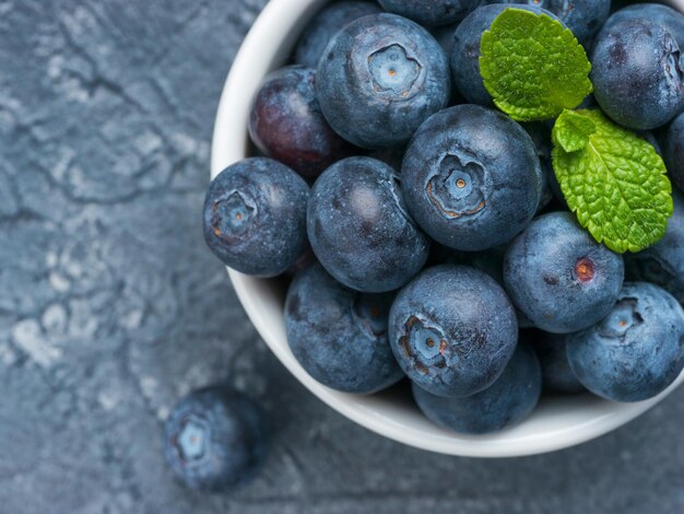 Blueberries in spoon on dark background