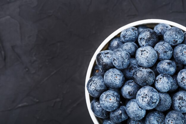 Blueberries in a white cup top view