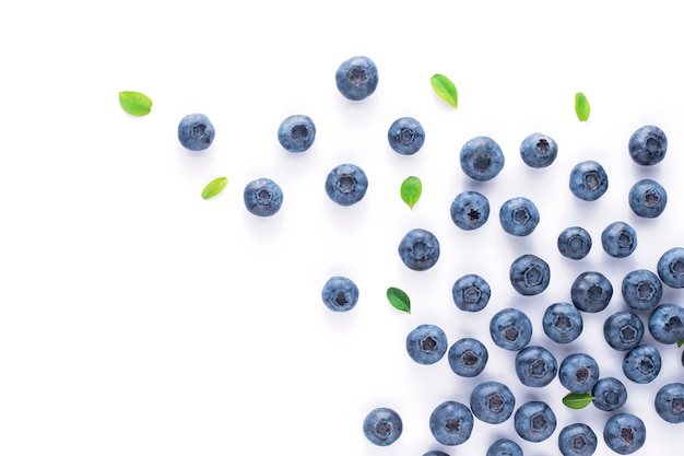 Blueberries with leaves on a white isolated background, fruit scatter.