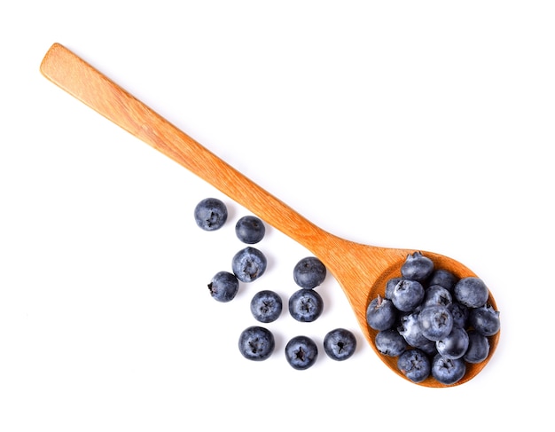 Blueberries in wooden spoon on white background