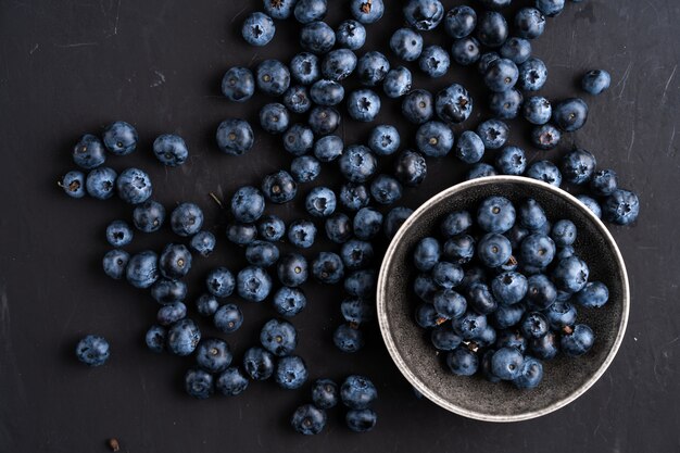 Blueberry antioxidant organische superfood in keramische kom voor gezond eten en dieetvoeding Bovenaanzicht op donker zwart