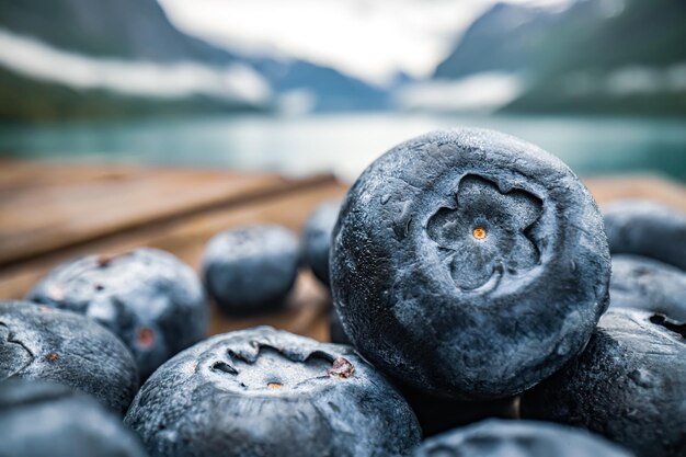 Photo blueberry antioxidants on a wooden table on a background of norwegian nature